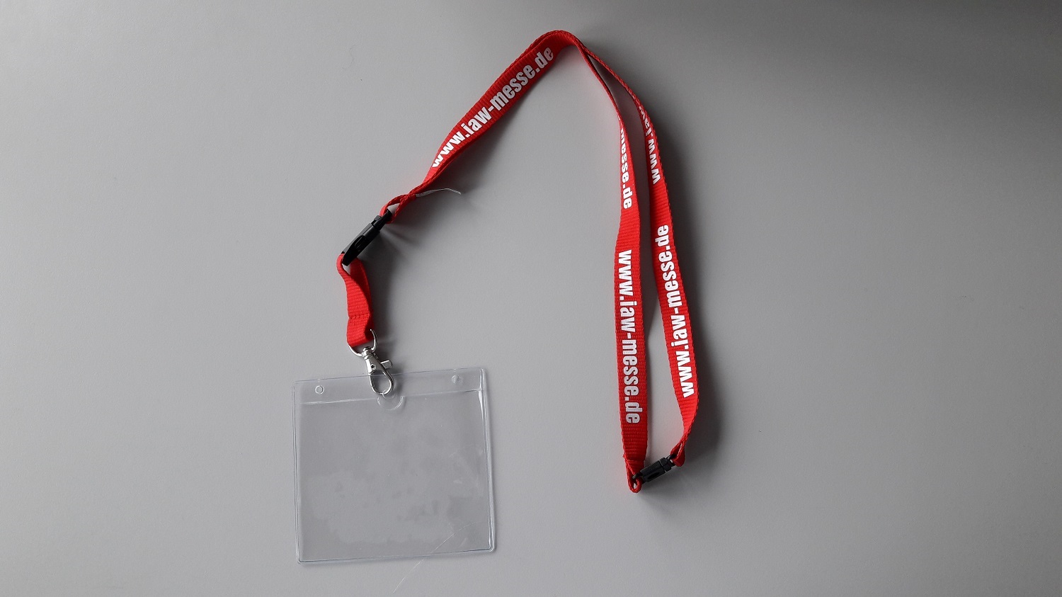 Umhängeband IAW mit Plastiktasche für